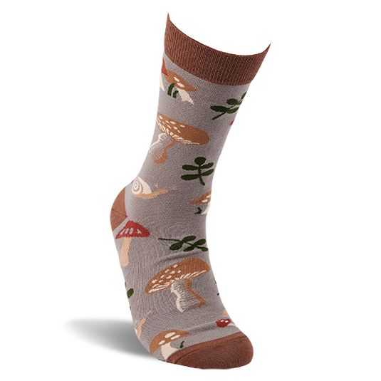 A single greyish-brown crew sock, worn on a foot, featuring mushrooms, leaves, and snails. Dark brown cuff, heel, and toe.