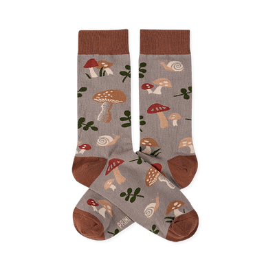 Two crew socks with a greyish-brown background, featuring a pattern of brown and red mushrooms, green leaves, and snails. Dark brown cuffs, heels, and toes.
