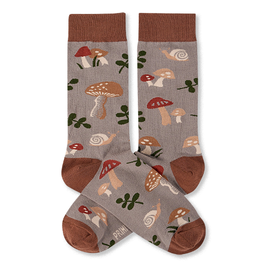 Two crew socks with a greyish-brown background, featuring a pattern of brown and red mushrooms, green leaves, and snails. Dark brown cuffs, heels, and toes.