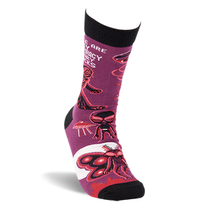 Single purple crew sock shown at an angle, featuring Mothman, alien, and UFO patterns with black cuff and toe.