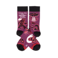 Pair of purple crew socks with black cuffs, heels, and toes, featuring Bigfoot, UFOs, aliens, and Mothman designs.