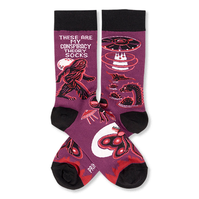Pair of purple crew socks with black cuffs, heels, and toes, featuring Bigfoot, UFOs, aliens, and Mothman designs.