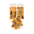 Pair of mustard yellow crew socks with off-white cuffs, heels, and toes, featuring a clothesline pattern with various small socks and the phrase 'THESE ARE MY ONLY CLEAN SOCKS'.