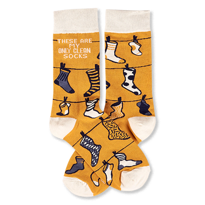 Pair of mustard yellow crew socks with off-white cuffs, heels, and toes, featuring a clothesline pattern with various small socks and the phrase 'THESE ARE MY ONLY CLEAN SOCKS'.