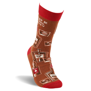 Single brown crew sock with red cuff, heel, and toe on a foot form, showing whiskey bottles and glasses pattern.