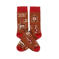 Pair of crew socks in brown with red cuffs, heels, and toes. Patterned with whiskey bottles, glasses, and text 'I'D RATHER BE SIPPING WHISKEY'.