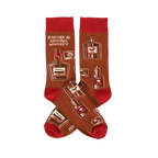 Pair of crew socks in brown with red cuffs, heels, and toes. Patterned with whiskey bottles, glasses, and text 'I'D RATHER BE SIPPING WHISKEY'.