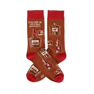 Pair of crew socks in brown with red cuffs, heels, and toes. Patterned with whiskey bottles, glasses, and text 'I'D RATHER BE SIPPING WHISKEY'.