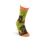 A single olive green and orange Bigfoot crew sock standing upright, showing the creature, forest, and 'Believe In Yourself' text.
