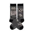 Pair of dark gray crew socks with black cuffs, heels, toes. Features raccoons, trash cans, and 'STAY TRASHY CREW' text.