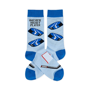 Light blue crew socks with blue cuffs, heels, toes. Features hockey pucks, net, stick, and 