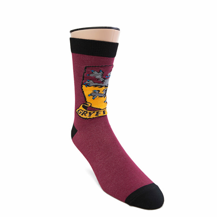 A burgundy sock with a black toe and heel. The sock features the crest of Gryffindor house from the Harry Potter series.