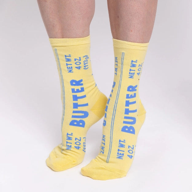 Yellow socks with blue text 'Butter' on a white background