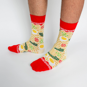 Close-up of a person's legs wearing the ramen crew socks, standing on a white background.