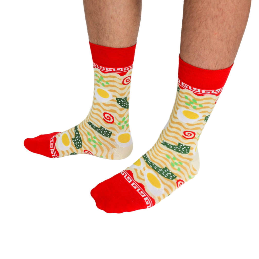 Close-up of a person's legs wearing the ramen crew socks, standing on a white background.