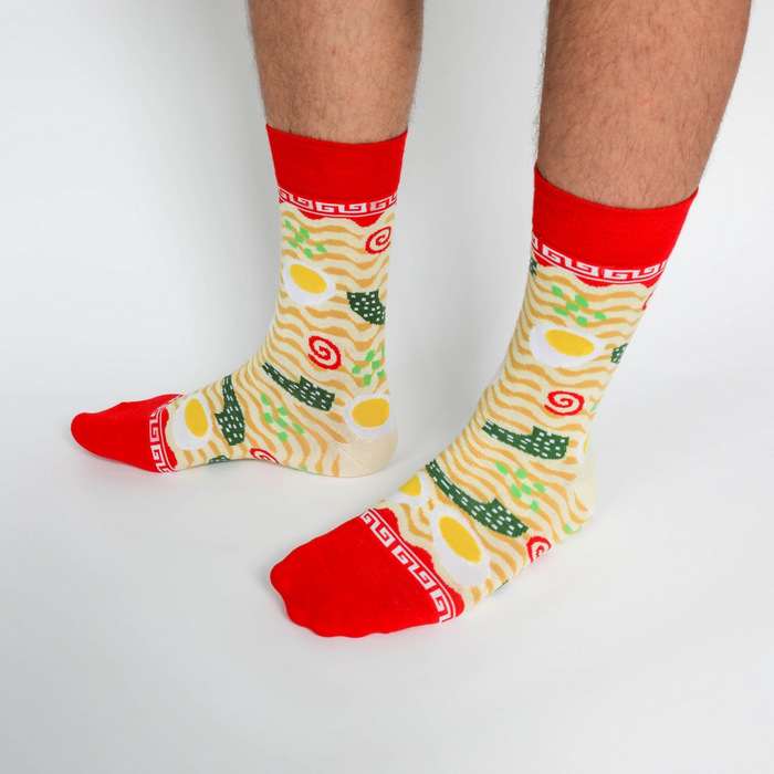 Close-up of a person's legs wearing the ramen crew socks, standing on a white background.