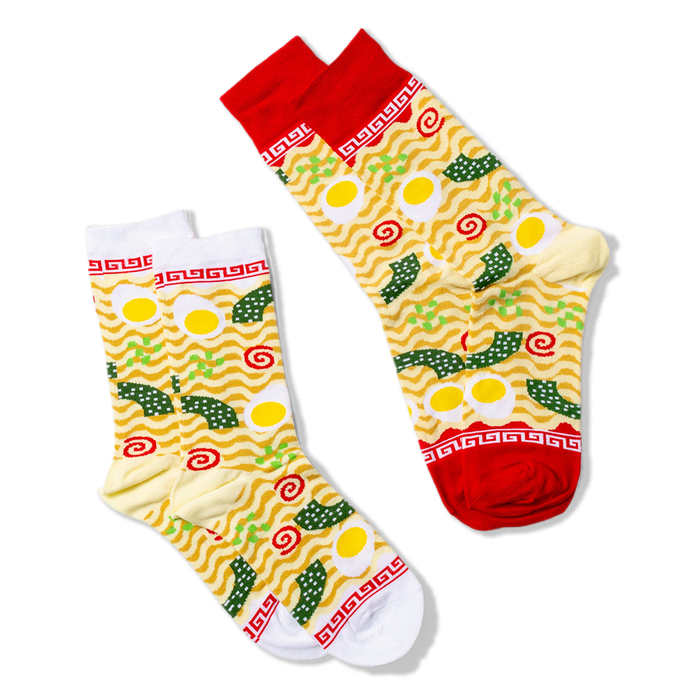 Two ramen crew socks on a black background; one with a white cuff and toe, the other with a red cuff and toe.