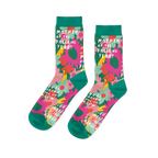 Pair of crew socks with pink, orange, and yellow flowers on a green background and teal cuffs, heels, toes.