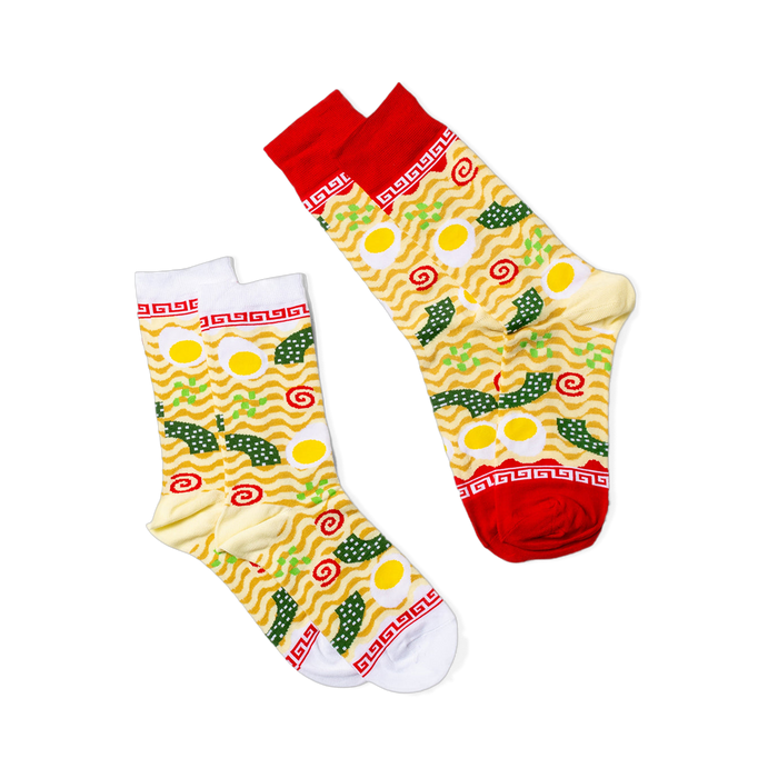 Ramen themed socks with wavy yellow noodles, fried eggs, green onions, and seaweed. Red & white cuffs feature a classic ramen