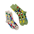 Two pairs of the same abstract art socks, one on a tan background and one on an olive green background, laid at an angle.