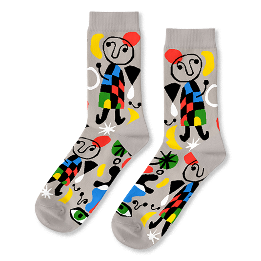 A pair of light grey crew socks with a vibrant abstract pattern, featuring black-outlined figures, colorful shapes, and green eyes.