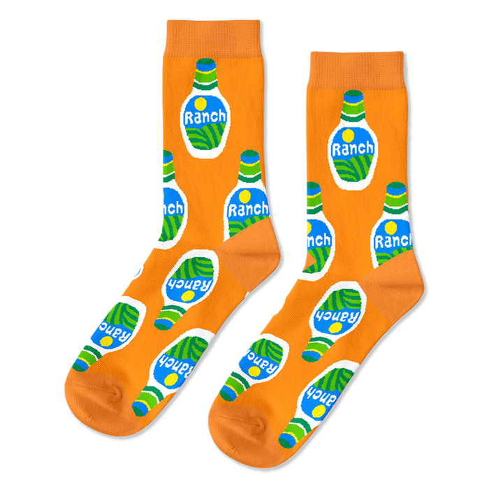 A pair of bright orange crew socks with an all-over repeating pattern of white ranch dressing bottles with green and blue accents.