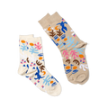 Two pairs of abstract art-patterned socks. One pair is tan, the other is cream, both with blue figures, faces, and shapes.