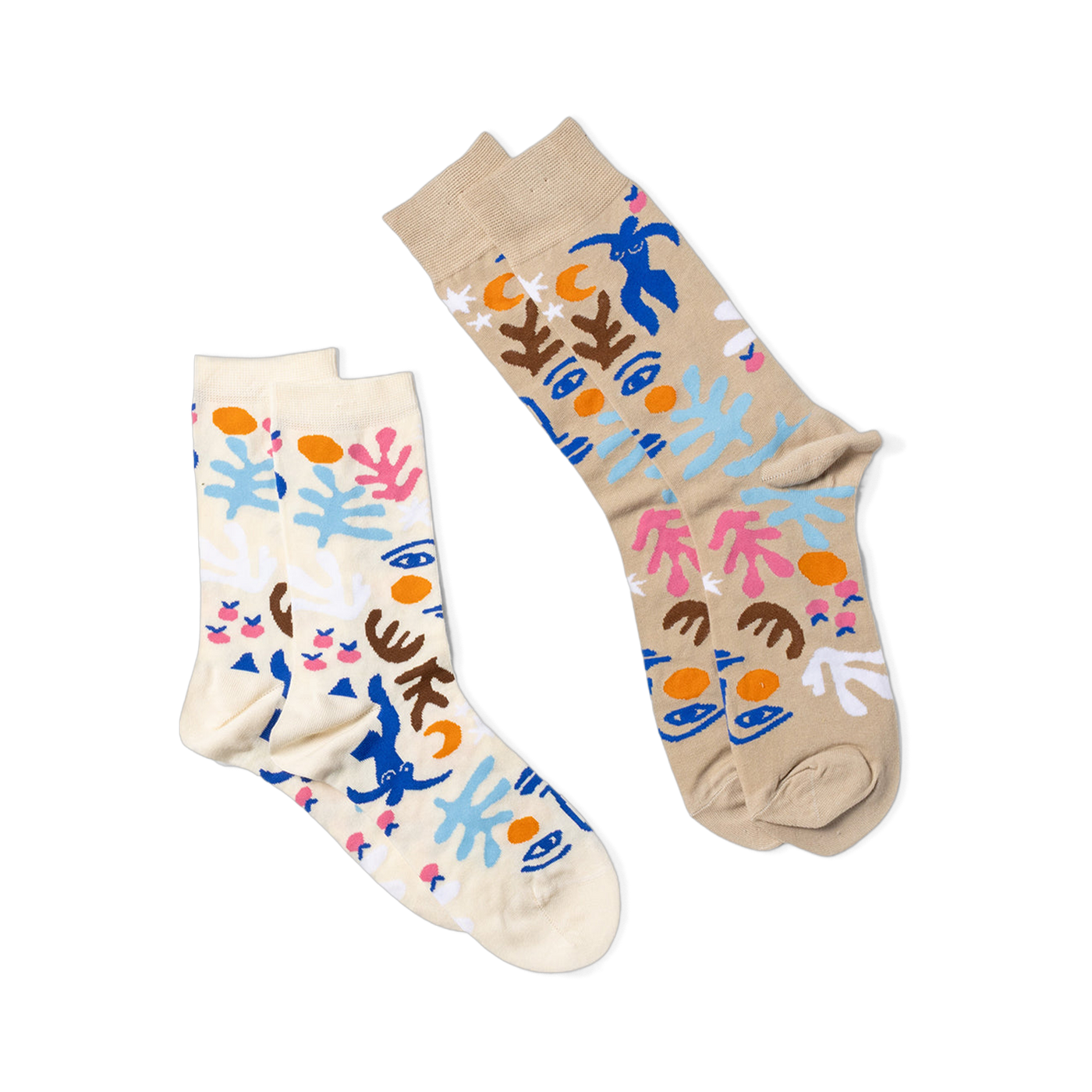 Two pairs of abstract art-patterned socks. One pair is tan, the other is cream, both with blue figures, faces, and shapes.