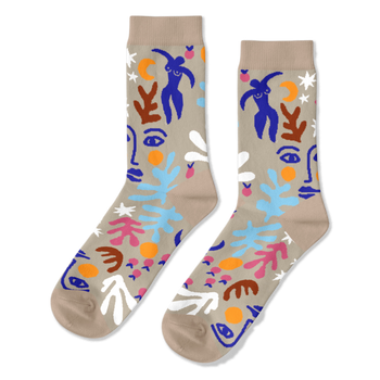 Pair of crew socks with an abstract Matisse-inspired pattern featuring blue figures, faces, stars, and leaves on a tan background.