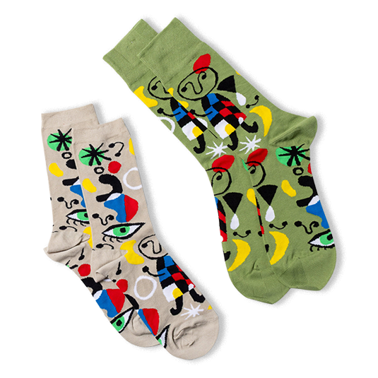 Two pairs of abstract art crew socks. One pair is olive green, the other light beige, both with colorful art patterns.