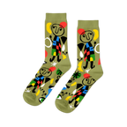 Pair of olive green crew socks with abstract art pattern, featuring stick figures, red stars, yellow moons, and colorful geometric shapes.