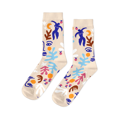 Pair of crew socks with abstract, Matisse-style cut-outs in blue, orange, pink, white, and brown on a cream background.