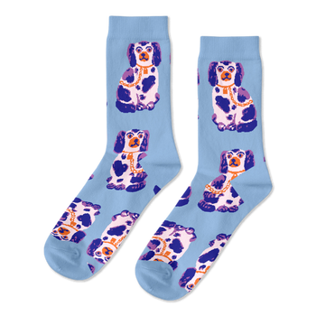 Pair of light blue crew socks, patterned with sitting white, dark blue, and purple Staffordshire dog figurines wearing gold chains.