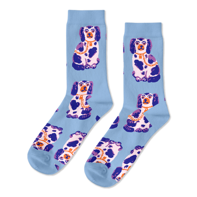 Pair of light blue crew socks, patterned with sitting white, dark blue, and purple Staffordshire dog figurines wearing gold chains.