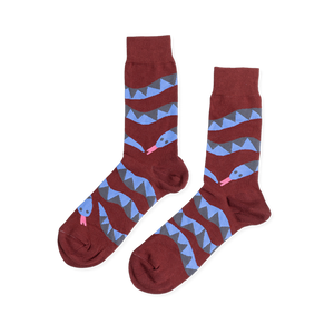 Pair of reddish-brown crew socks laid flat, featuring coiled blue and gray snake patterns with pink tongues, on a white background.
