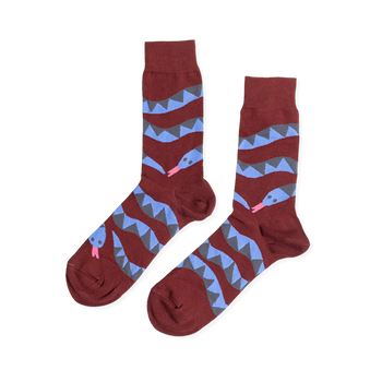 Pair of reddish-brown crew socks laid flat, featuring coiled blue and gray snake patterns with pink tongues, on a white background.