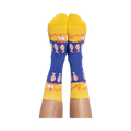 A person's feet wearing the blue and yellow anchovy crew socks, with the pattern of fish and text clearly visible.