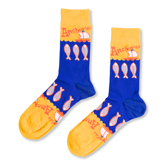 Pair of blue and yellow crew socks with a pattern of silver anchovy fish, 'Anchovies' text, and small sailboats.