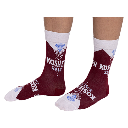 Person wearing deep red Kosher Salt crew socks, stretched over visible lower legs, showing the full design.
