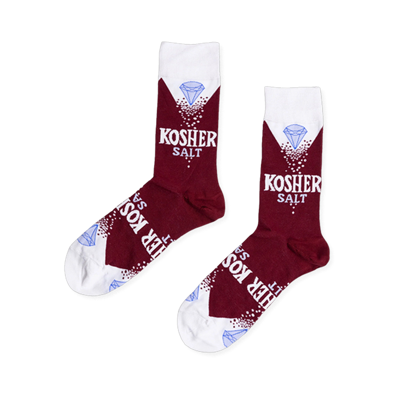Pair of deep red crew socks with white cuffs, heels, and toes, featuring "KOSHER SALT" text, white sprinkles, and a blue diamond.