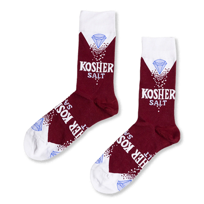 Pair of deep red crew socks with white cuffs, heels, and toes, featuring "KOSHER SALT" text, white sprinkles, and a blue diamond.