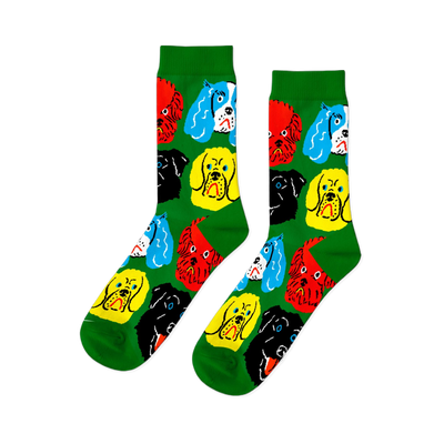 A pair of bright green crew socks featuring a repeating pattern of colorful cartoon dog faces in red, yellow, black, and blue.