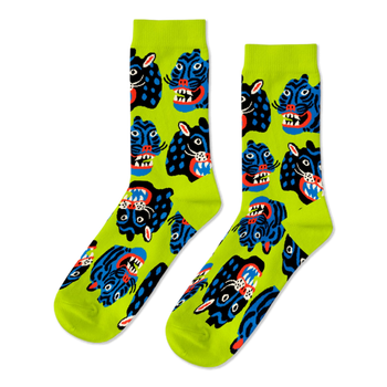 Pair of crew socks with a repeating pattern of stylized black and blue wild cat faces, snarling, on a neon lime green background.