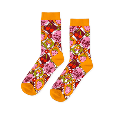 Pair of crew socks in a retro pattern. Features orange, pink, red, and green squares with cherries, strawberries, mushrooms, and the phrase 'fuck off'.