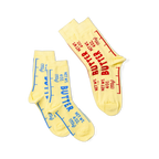 Two yellow crew socks, one pair with blue 'BUTTER' text, and a single sock with red 'BUTTER' text, displayed together.