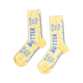 Pair of yellow crew socks designed like butter sticks, featuring blue 'BUTTER' text and net weight measurements.