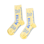 Pair of yellow crew socks designed like butter sticks, featuring blue 'BUTTER' text and net weight measurements.