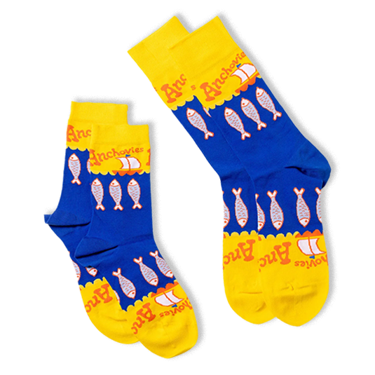 Two folded blue and yellow crew socks overlapping each other, showing the anchovy fish pattern and scalloped wave borders.