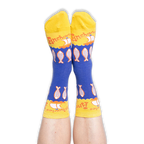 Person wearing blue and yellow anchovy socks with their feet pointed up against a black background, showing the toe design.