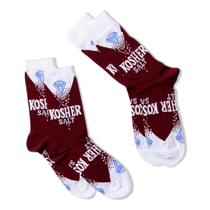 Two pairs of Kosher Salt socks, folded flat and angled diagonally on a black background, showing the full design.